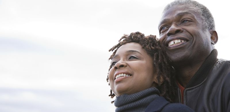 man and a woman smiling looking up